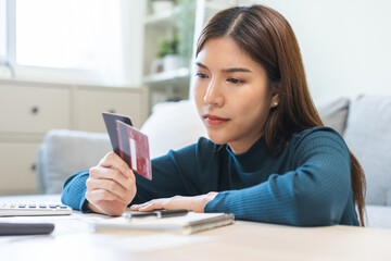 Business financial concept, stressed asian young business woman hand holding credit card for...