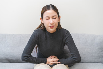 Flatulence ulcer, asian young woman, girl hands in belly, stomach pain from food poisoning,...