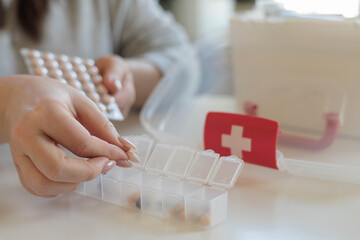 A woman takes her daily sedative or medicine for a headache or stomach pain.
