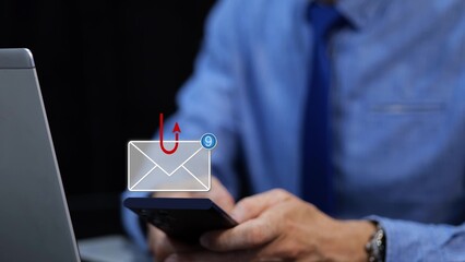 Businessman receiving messages on his phone during a phishing attack. 3D graphic of email and hook