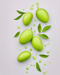 Green Fruits with Leaves and Gold Sprinkles on Pale Grey Background