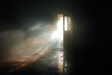 A door is open in a dark room with a light shining through it