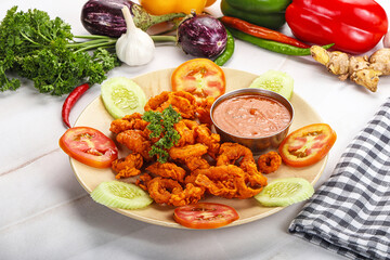 Golden fried crispy calamari with sauce