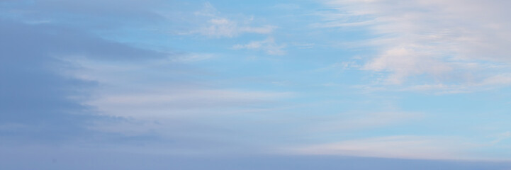 Blue sky background with clouds. Wide panoramic background for design.