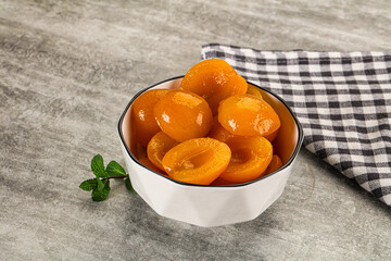 Sweet canned apricots with syrope