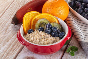 Oats porridge with blueberry, kiwi and orange