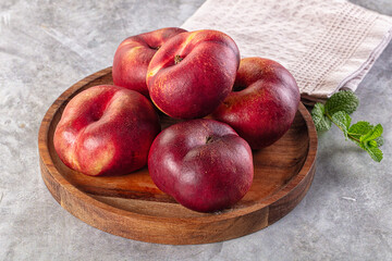 Ripe sweet juicy flat nectarines heap