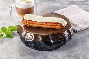 White vanilla eclair with icing