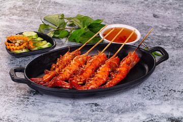 Grilled prawn skewer served sauce