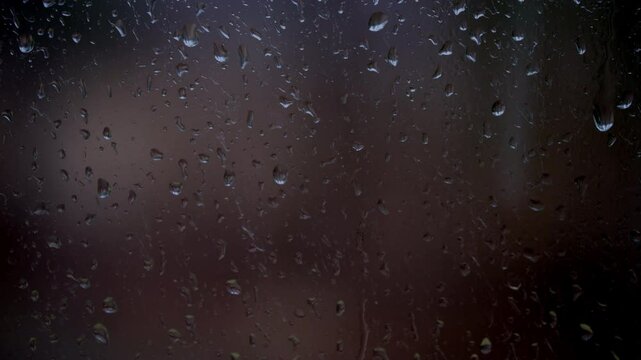 Drops of the rain sliding down slowly on window glass, rainstorm, rainy season, 