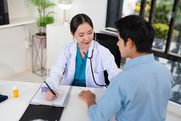 Asian doctor talk with patient about disease symptom, doctor use stethoscope listening lung of...