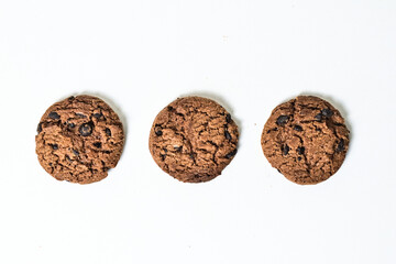Top view of three chocolate chip cookies isolated on white background. Close up. clipping path. high angle, above.