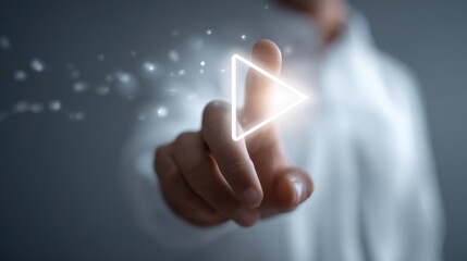 A hand pressing a glowing play button, symbolizing innovation and digital advancement.