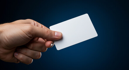 Hand holding a blank white card mockup on blue background