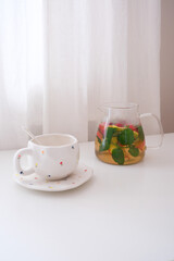 Invigorating Herbal Tea Infused with Fresh Mint and Seasonal Fruits Displayed in a Bright Setting
