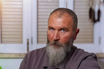 Portrait of a man with a gray beard.