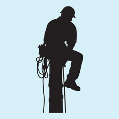 Black Silhouette of a Utility Lineman on Pole