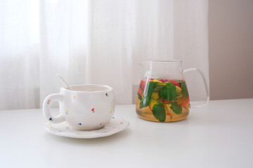 Invigorating Herbal Tea Infused with Fresh Mint and Seasonal Fruits Displayed in a Bright Setting