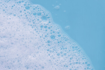 Blue water with white foam bubbles