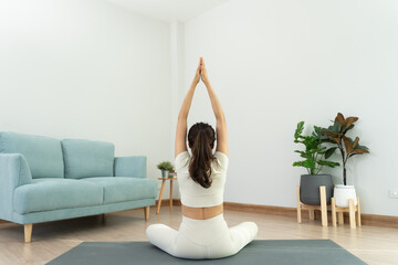 Slim woman practicing yoga on room at condo or home. Asian woman doing exercises in morning....