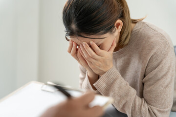 woman with mental health problems is consulting. psychiatrist is recording the patient's condition...