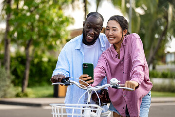 Interracial couple enjoying smartphone technology, staying connected, sharing moments. Travel people