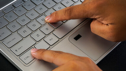 Close up view of finger pressing control and D letter button or ctrl + D shortcut keys on laptop keyboard isolated on black background