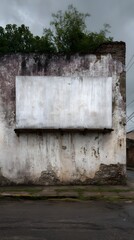 Weathered blank billboard on an old building wall with peeling paint