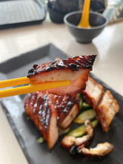 Closed-up of Cantonese honey glazed barbecued Char Siew or Char Siu (barbecued roast pork), picked...