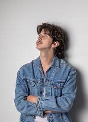 Vertical photo of man in denim jacket. Studio photo