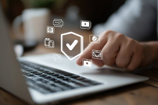Hand touching laptop with digital security - related icons like shield and check - mark floating, suitable for cybersecurity, online safety, and digital protection use cases. 