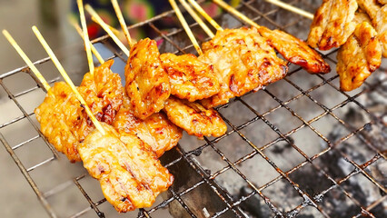 Thai grilled pork skewers (Moo Ping), Thai street food: A close-up shot captures the allure of pork...
