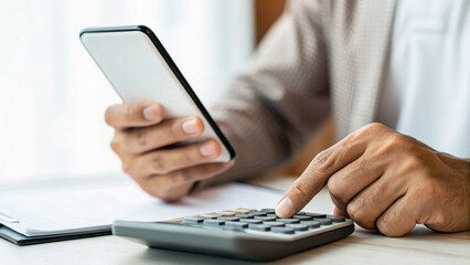 Cost of living inflation. Man using smartphone and calculator, financial planning, cost of living increase, business attire ,rising prices,financial pressure,economic crisis