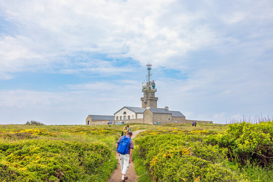 Hikers on the way to a radar station at  pointe du raz in Bretagne, France