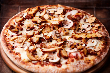 Gyros Pizza with with champignons and mozzarella cheese. Wooden background. Soft focus.	