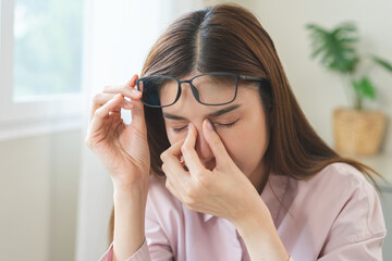 Eye problem concept, fatigue asian young woman tired eyes, irritated rubbing nose, relief vision...