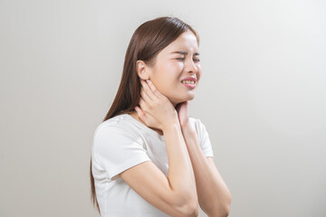 Sickness in inflaming asian young woman, girl use hand check self touch at sore throat, pain...