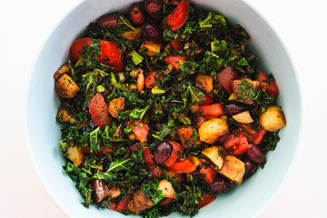 salad with air fried kale, tomatoes, potatoes, capers and olives