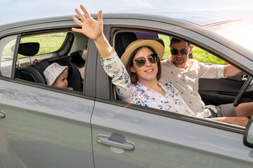Family in car. Man woman child traveling. Summer adventure road smile.