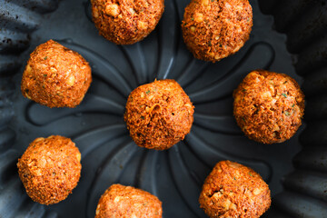 homemade chickpea falafels with paprika cumin and coriander on black plate