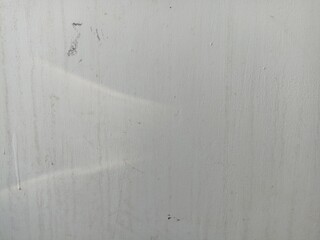 Subtle White Wall Texture. A close-up of a lightly textured white wall with faint marks and subtle...