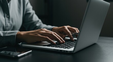 Focused Typing: Hands on Laptop Keyboard, Dark Desk, Modern Technology, Close-up.