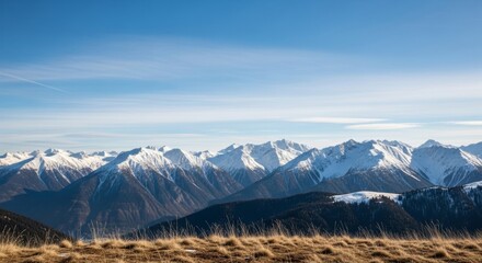 Majestic Snowy Mountain Range Under a Clear Blue Sky Landscape.