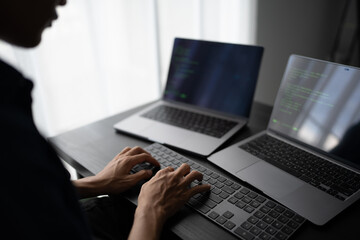 Asian man software engineer Working on Computer at office desk for writing program code IT Software...