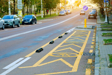 Traffic markings and signage on road near school, designated stop area for safe child transport, outlined with yellow paint and lane separators. School pickup zone with visible yellow markings
