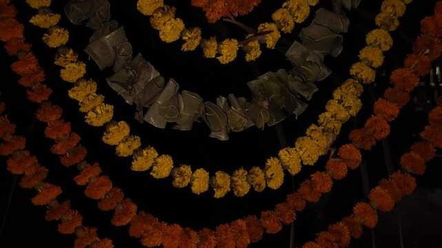 Beautiful marigold flower garland with green mango leaves hangs as a traditional decorative border in the background, symbolizing Indian culture, religion, and festive celebrations like Diwali, Pongal