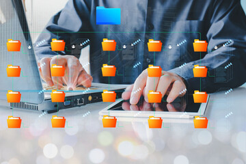 Folder gradation structure and document management system DMS. Businessman using laptop computer...