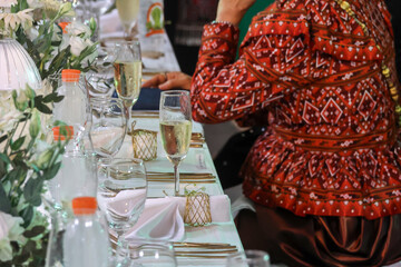 Champagne Glasses On The Dinner Table. At a wedding in Thailand, there are alcoholic welcome drinks in clear glasses.