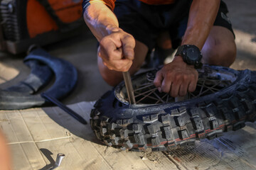 Selective Focus: New motocross tires are being pryed out with a tire iron.