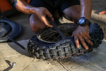 Selective Focus: New motocross tires are being pryed out with a tire iron.
